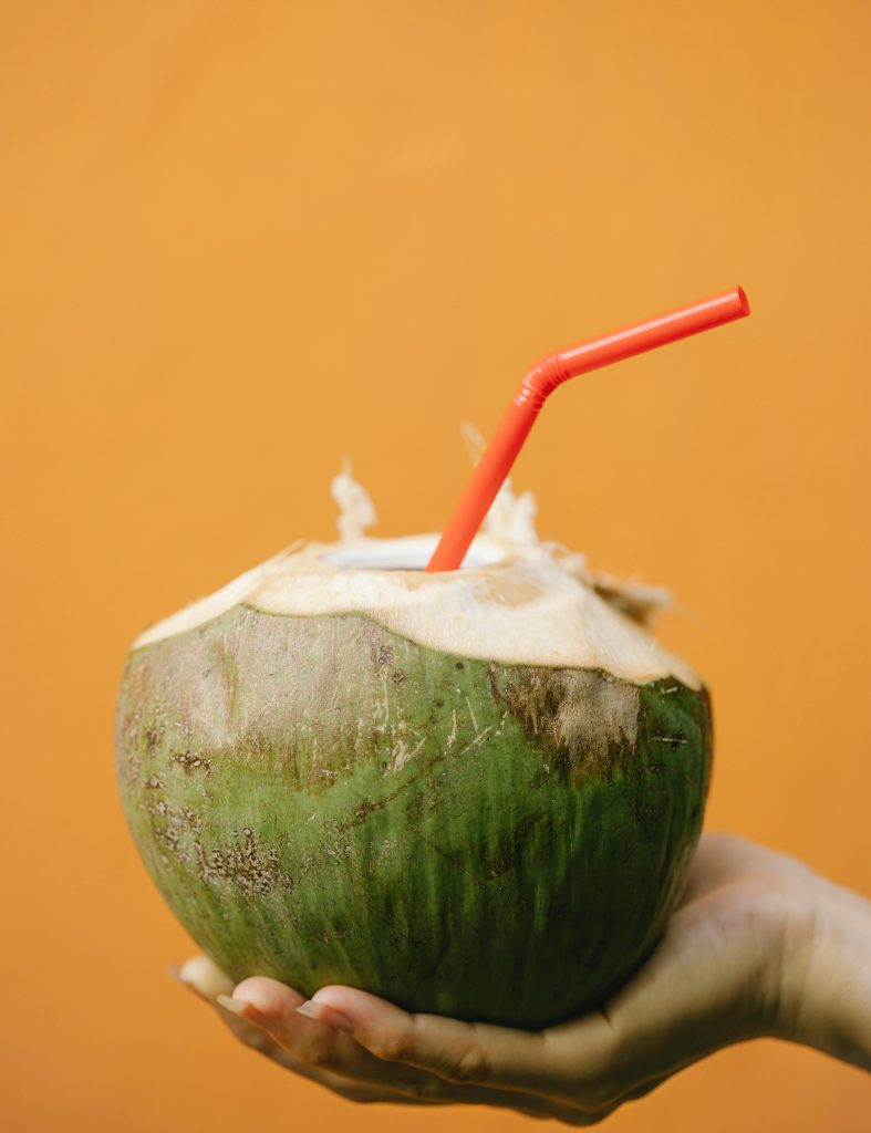 a photo of a coconut with a straw