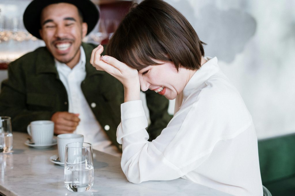 Image of two individuals laughing together