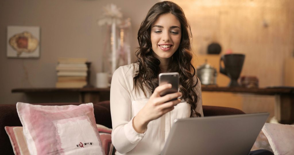 woman smiling at her phone