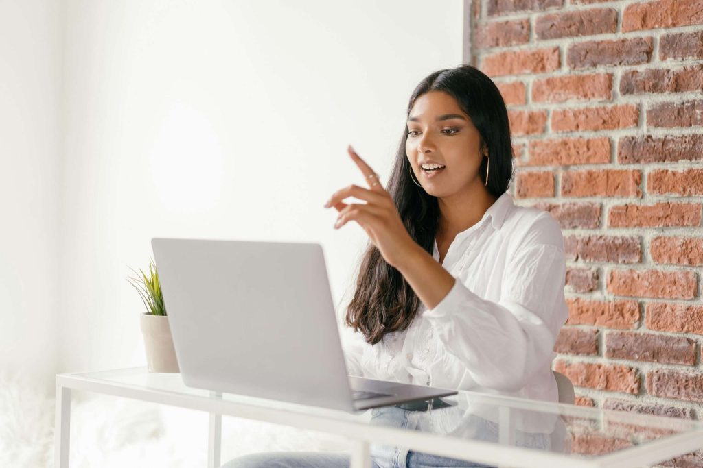 a woman speaking on a video conference on a computer